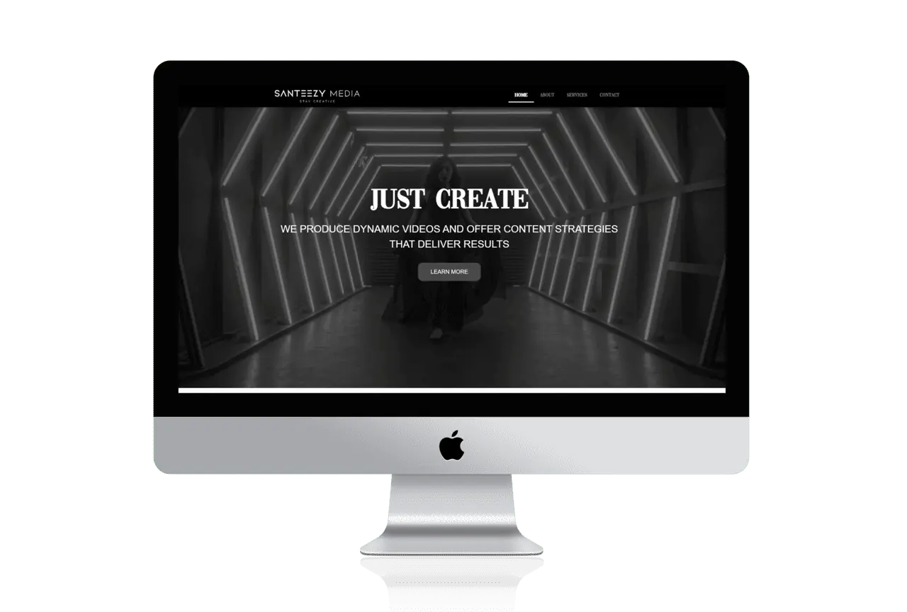 A web design displayed on a computer screen with the words just create.