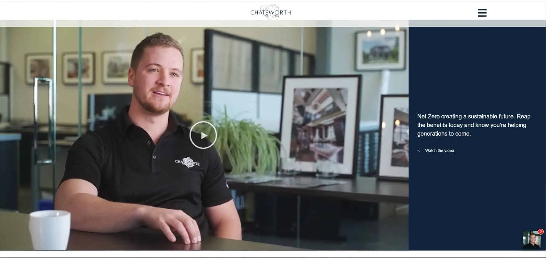 A website with a man sitting in front of a desk.