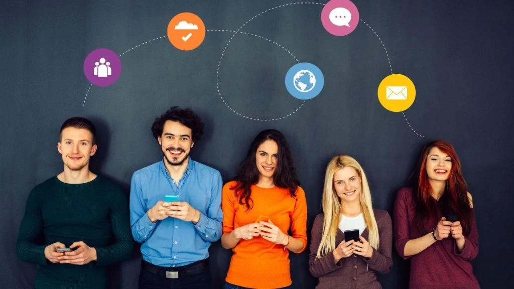 A group of social media experts standing in front of a wall with social media icons.