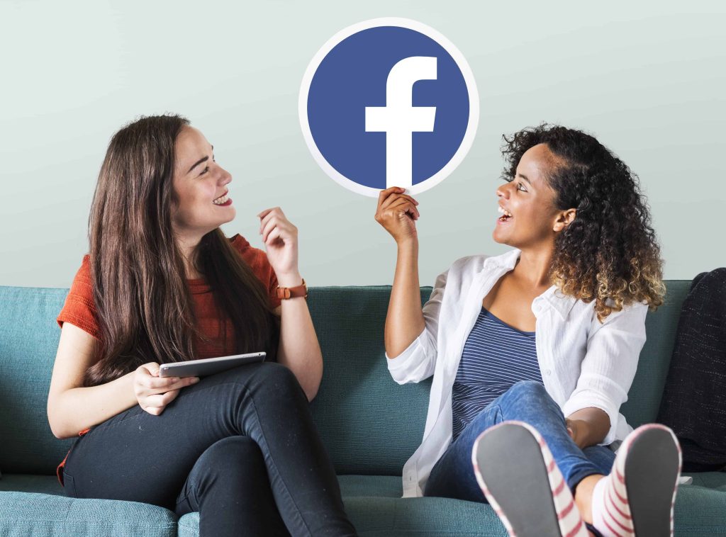 Social Media And Business: Choose The Right Platform For Your Business young women showing facebook icon 1