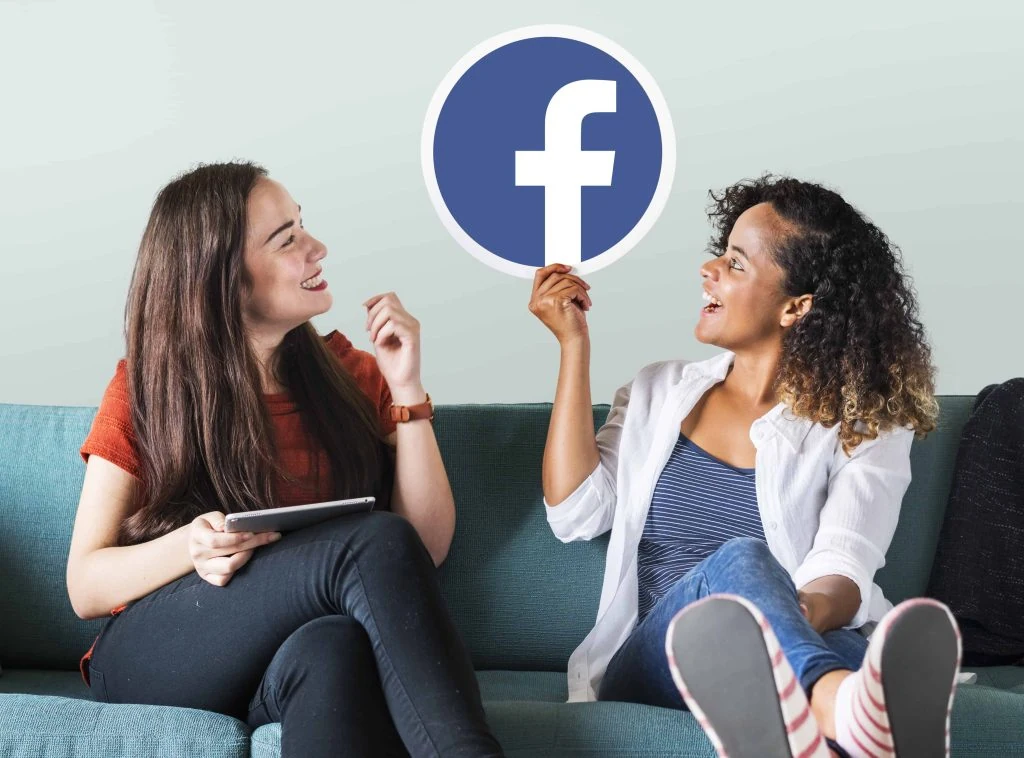 young women showing facebook icon 1